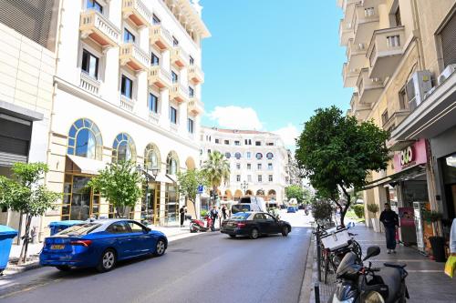 a city street with cars parked on the side of the road at Thessaloniki Center Aristotelous Apartment in Thessaloniki