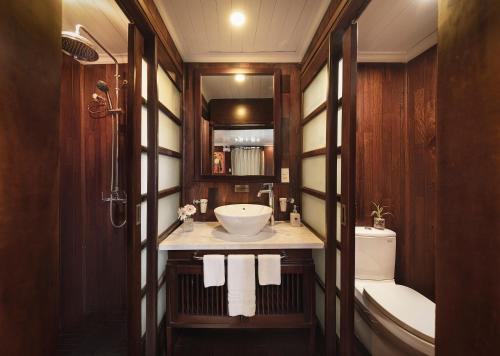 a bathroom with a sink and a toilet at Bhaya Halong Cruises in Ha Long