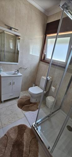 a bathroom with a toilet and a sink at Casa da Praia in Póvoa de Varzim