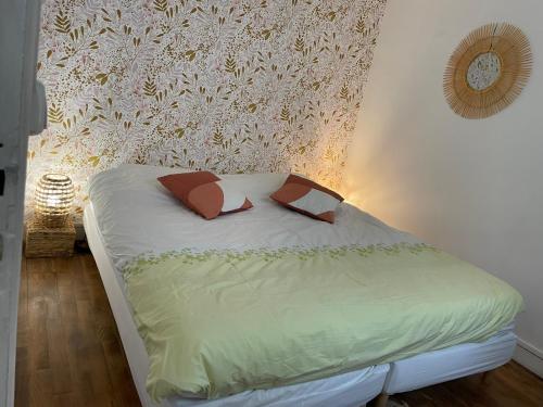 a bed with two pillows on it in a bedroom at Bayeux in Bayeux
