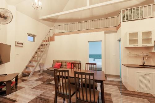 a kitchen and living room with a table and chairs at บ้านกันเอง Baan Kun Aeng Homestay in Ban Kat Nua