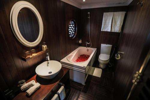 a bathroom with a sink and a bath tub at Bhaya Halong Cruises in Ha Long