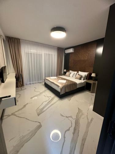 a bedroom with a bed and a marble floor at The View - Sabrina Premium Villa in Brca