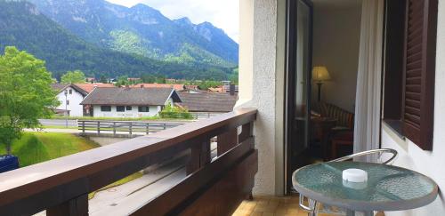 a balcony with a table and a view of a mountain at Alpenhotel Gastager in Inzell