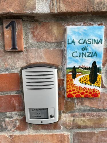 a computer on a brick wall with a picture at La Casina di Cinzia in San Gimignano