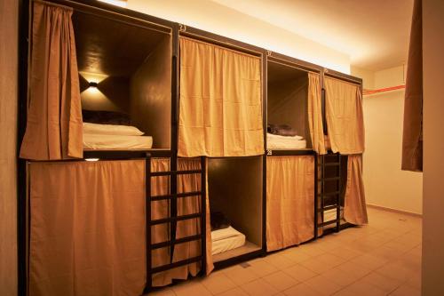 a room with three bunk beds in a room at Some Place Else in George Town