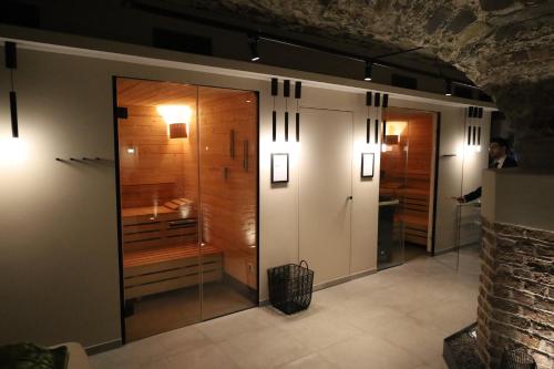 a room with two glass doors and a bathroom at Hotel Villa Sanct Peter in Bad Neuenahr-Ahrweiler
