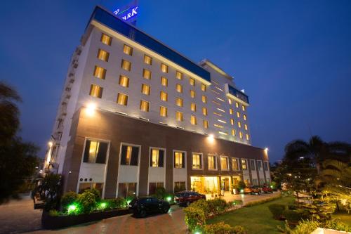 a large building with cars parked in front of it at Gokulam Park Coimbatore in Coimbatore
