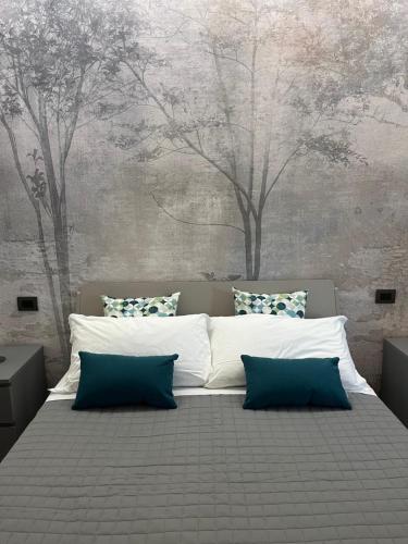 a bedroom with a large bed with trees on the wall at La Casina di Cinzia in San Gimignano