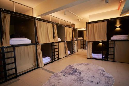 a room with multiple bunk beds with a rug at Some Place Else in George Town