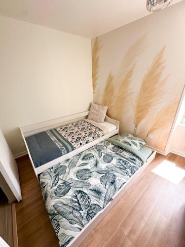 um pequeno quarto com duas camas em La petite M em Tréméreuc