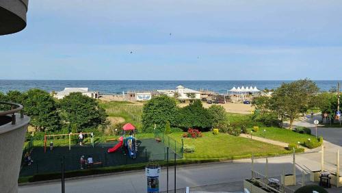 a view of a park with a playground and the ocean at Infinity view 2 Shkorpilovci in Shkorpilovtsi