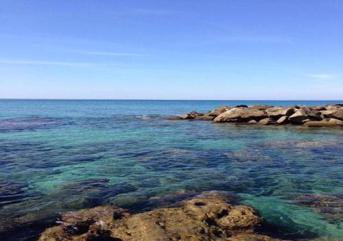 a view of the ocean with rocks in the water at L'albero di limoni sul mare di Pizzo in Pizzo