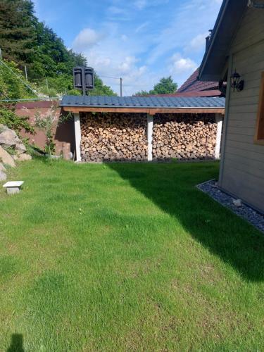 a backyard with a stone wall and a building at Chata pod hradom 1 in Uhrovské Podhradie