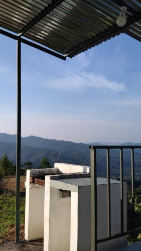a balcony with a view of the mountains at Hawun Valley Kiulu in Tamparuli