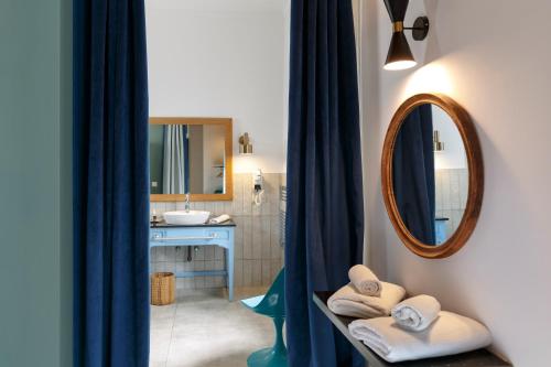 a bathroom with a sink and a mirror at Riad Tamayourt Ocean View & piscine chauffée à 30 in Essaouira