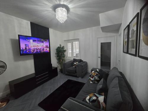 a living room with a couch and a flat screen tv at Lily in Blackpool