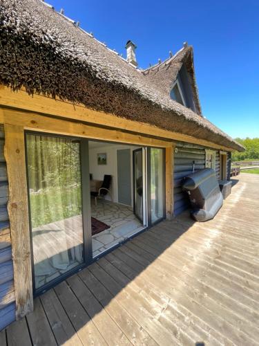 a deck with sliding glass doors on a house at Abruka Boutique Spa in Abruka