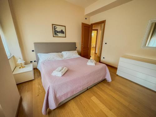 a bedroom with a bed with two towels on it at Casa Paolina in Lucca