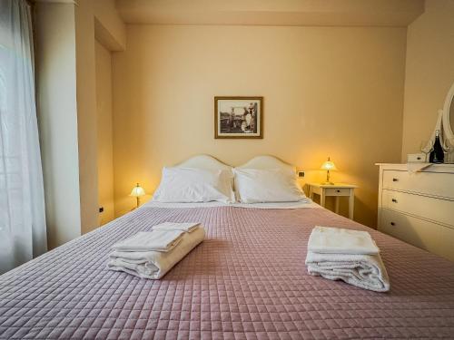 a bedroom with a bed with two towels on it at Casa Paolina in Lucca