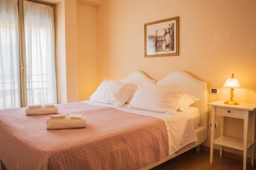a bedroom with a bed with two towels on it at Casa Paolina in Lucca