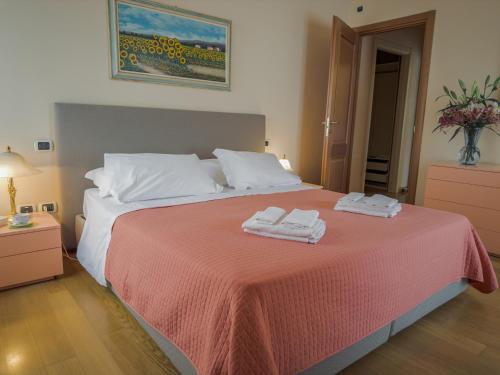 a bedroom with a bed with two towels on it at Casa Paolina in Lucca