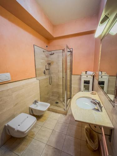 a bathroom with a toilet and a sink and a shower at Casa Paolina in Lucca