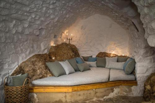 a bed in a stone wall with lights on it at Kapetan Matapas 16th Cen. Tower in Areopoli