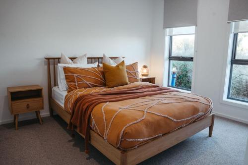 a bedroom with a large bed with pillows at Southern Pause Port Campbell in Port Campbell