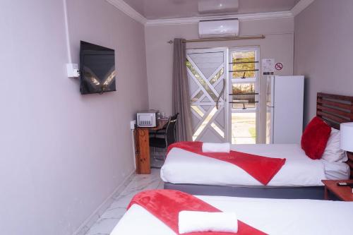 a hotel room with two beds and a window at Safi Suites and Conference Centre in Mthatha