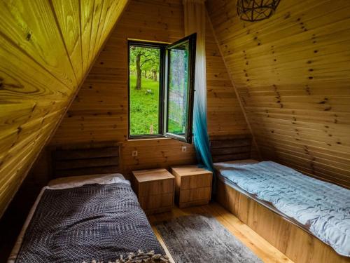 Habitación con 2 camas en una cabaña de madera en KALOHOUSE, en Dandalo
