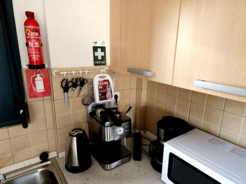 a kitchen counter with a coffee maker on the wall at Traumhafte Maisonette in Possidi am Strand in Possidi