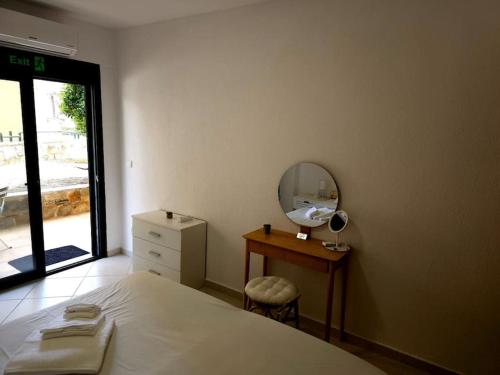 a bedroom with a bed and a mirror and a dresser at Traumhafte Maisonette in Possidi am Strand in Possidi