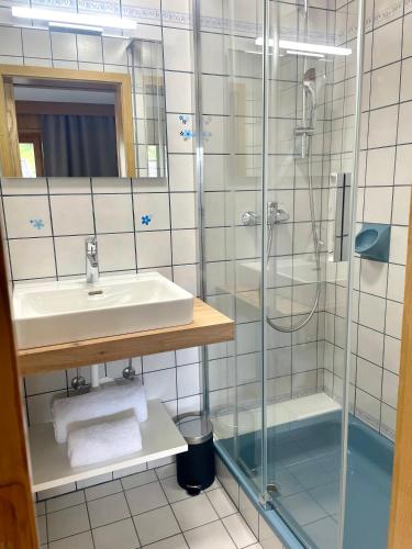 a bathroom with a sink and a shower at Ferienwohnung Soller in Bramberg am Wildkogel