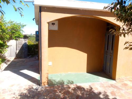 a door to a house with a pool of water at Esam Homestay in Sekenani