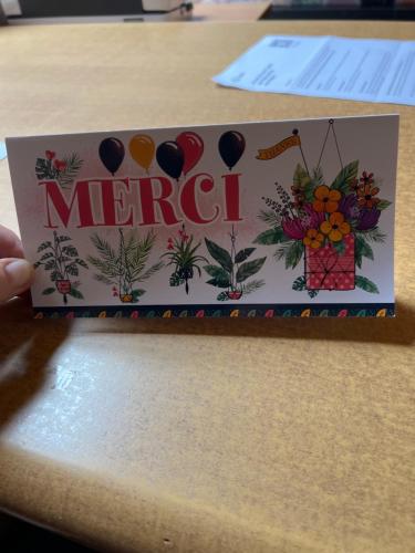 a sign on a table with the word merci at Résidence du moulin 2 B 2 pour 4 personnes in Boussu