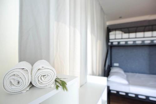 two rolled towels sitting on a counter in a bedroom at Belsun Hotel in Beldibi