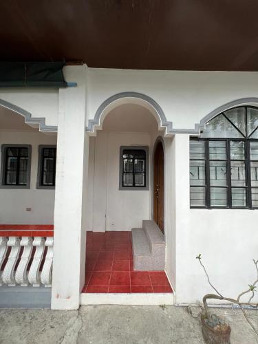 an entrance to a house with a red tile floor at SSC Transient House & Staycation - Imus in Imus
