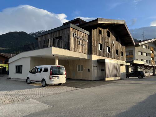 a white van parked in front of a building at Penthouse Julia nähe Badesee mit Infrarotsauna -Zell am See Kaprun in Niedernsill
