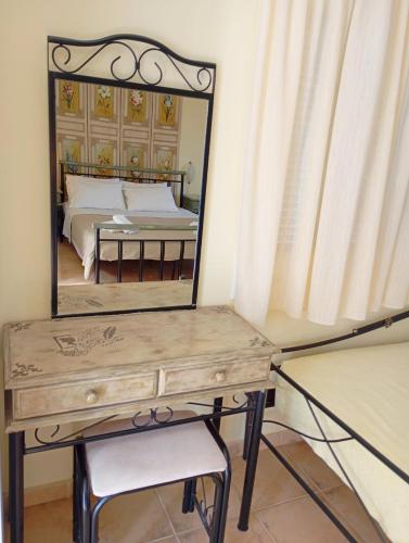 a dressing table with a mirror on top of it at Odysseion Apartments in Vathi, Ithaka