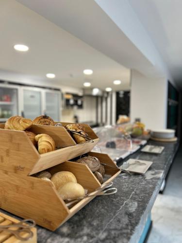 a bakery counter with baskets of pastries on it at Alma Candida 25 in Azenhas