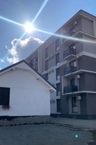 a building with a white garage in front of it at Apartament Radiana in Baile Felix