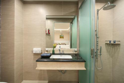 a bathroom with a sink and a shower at The Light Hotel in Hanoi