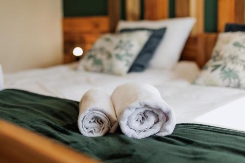 two rolled towels sitting on top of a bed at Jesteśmy Na Ty - Apartamenty in Lewin Kłodzki