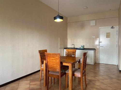AiRia Resident Apartment في Kampong Batu Empat Belas: غرفة طعام مع طاولة وكراسي في مطبخ