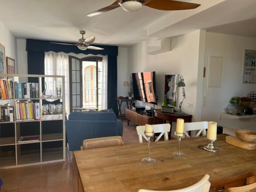 a living room with a dining room table with a ceiling fan at Luxury penthouse Apartment in Cuevas del Almanzora