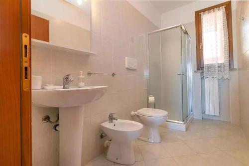 a bathroom with a sink and a toilet and a shower at La Fonte degli Angeli Apartments in Suvereto