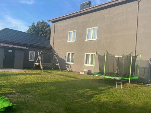 a yard with a building with a tent in it at Gaspard in Sarbinowo