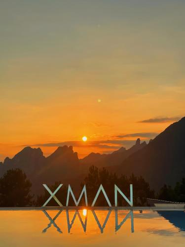 a sign that says wow in front of a sunset at XMAN Sunrise Peaks Resort--Free Pick-up in Zhangjiajie
