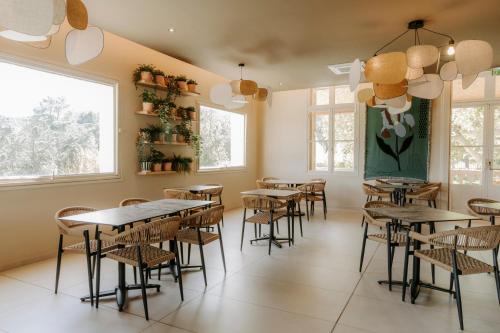 a restaurant with tables and chairs in a room at Soko Hotels-Pont du Gard in Remoulins